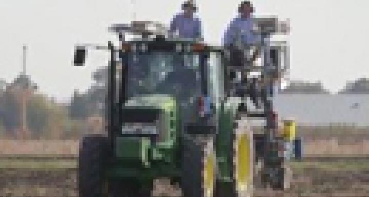 Two men on a tractor